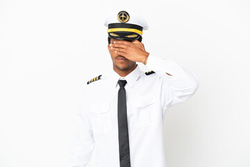 African American Airplane pilot over isolated white background covering eyes by hands. Do not want to see something © luismolinero