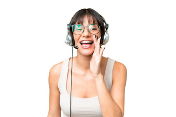 Telemarketer caucasian woman working with a headset over isolated background shouting with mouth wide open