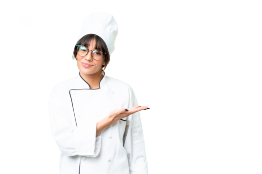 Young caucasian chef  woman over isolated chroma key background presenting an idea while looking smiling towards