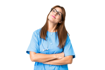 Middle age nurse woman over isolated background looking up while smiling