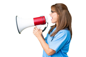 Middle age nurse woman over isolated background shouting through a megaphone