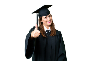 Middle age university graduate woman over isolated background with thumbs up because something good...