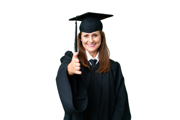 Middle age university graduate woman over isolated background shaking hands for closing a good deal