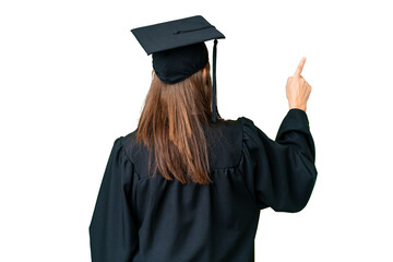 Middle age university graduate woman over isolated background pointing back with the index finger