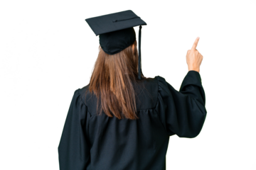 Middle age university graduate woman over isolated background pointing back with the index finger
