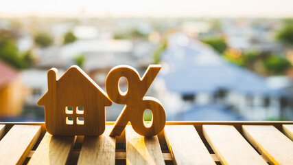 Percentage and house sign symbol icon wooden on wood table. Concepts of home interest, real estate,...