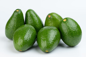 Shiny green avocado pile