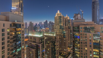 Fototapeta na wymiar Dubai skyscrapers with golden sky over business bay district day to night timelapse.