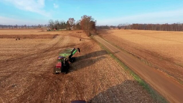 Drone Circling Grain Cart Pulling Up to Semi Truck