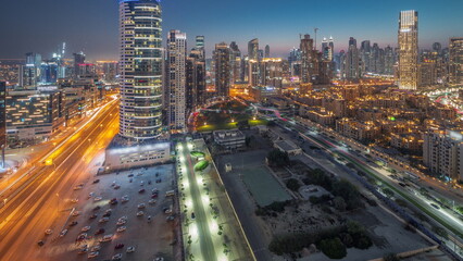 Fototapeta na wymiar Dubai's business bay towers aerial day to night timelapse. Rooftop view of some skyscrapers