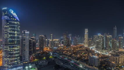 Fototapeta na wymiar Panorama showing Dubai Downtown and business bay night timelapse with tallest skyscraper and other towers