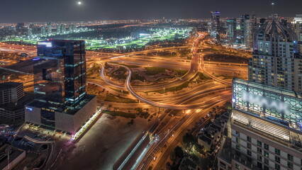 Panorama showing Dubai marina and JLT skyscrapers along Sheikh Zayed Road aerial night timelapse.