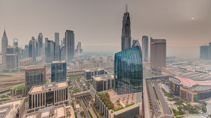 Futuristic Dubai Downtown and finansial district skyline during sunrise aerial timelapse.