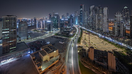 Fototapeta na wymiar Panorama showing Bay Avenue with modern towers residential development in Business Bay aerial night timelapse, Dubai