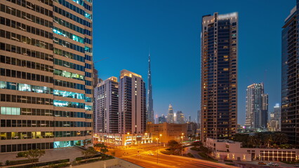 Fototapeta na wymiar Aerial panoramic view to Dubai downtown and difc skyscrapers day to night timelapse.