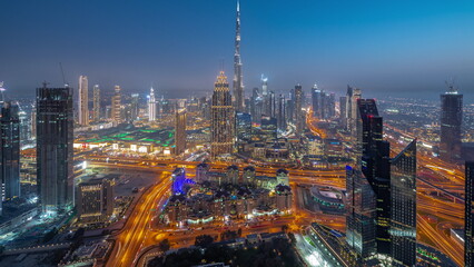 Fototapeta na wymiar Aerial view of tallest towers in Dubai Downtown skyline and highway day to night timelapse.