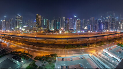 Fototapeta na wymiar Panorama of Dubai Marina skyscrapers and Sheikh Zayed road with metro railway aerial day to night timelapse, United Arab Emirates