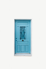 Front view of a light blue door with iron knob and central window protected with wrought iron on white isolated background.