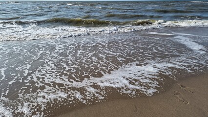 North Sea, Kijkduin, Netherlands. Waves breaking on the sandy shore of the North Sea, in spring. 