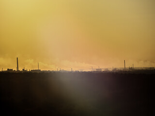 Silhouettes of factories on the horizon