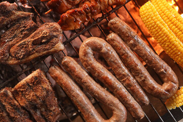 South African braai. Boerewors, chops, chicken kebabs and mielie or corn on the cob on the grill