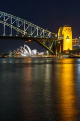 Papier Peint photo Sydney Harbour Bridge A symphony of design and engineering: Sydney's iconic Opera House and Harbour Bridge.