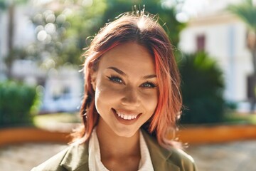 Young caucasian woman smiling confident standing at park