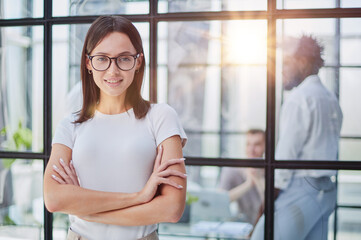 business woman with her staff in background at office