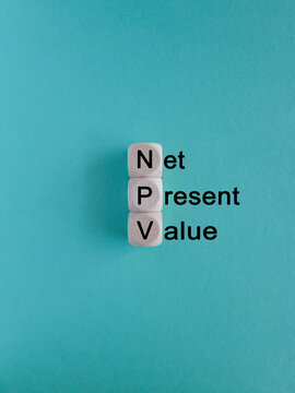 NPV net present value symbol. Concept words NPV net present value on wooden cubes on a beautiful blue background. Business and NPV net present value concept. Copy space.