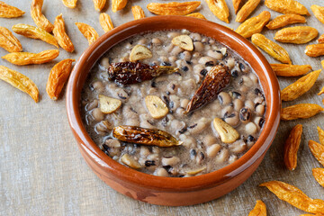 Vegan Frijoles refritos. Refried beans with fried garlic and chili on coconut oil. Dried chilies on...