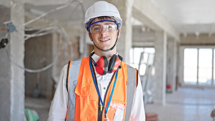 Young caucasian man architect smiling confident standing at construction site