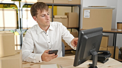 Young caucasian man ecommerce business worker using smartphone and computer at office