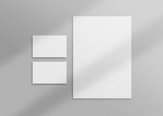 Realistic top view cover and opened portrait A4 or A5 magazine or brochure booklet for stationery and branding. Mockup template isolated light grey background and leaf shadow overlay. 3D rendering.