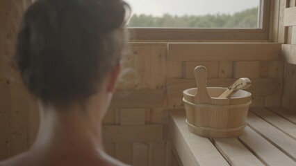 Woman relaxing and sweating in hot sauna. Real, authentic sauna moment.