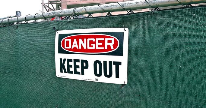 "Danger, Keep Out" sign on the fence of the construction site in Los Angeles, California, 4K