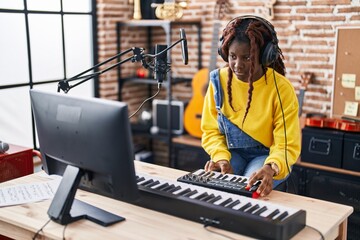 African american woman musician having dj session at music studio