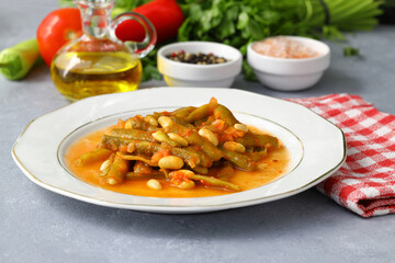 Homemade stewed green beans, tomatoes, garlic with olive oil. Zeytinyagli fasulye traditional food. Turkish cuisine.