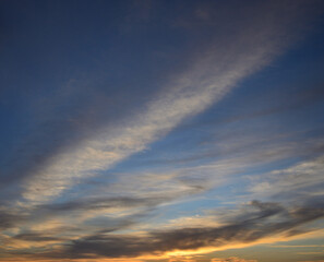 Beautiful sky at sunrise with scattered clouds and blue, white and yellow tones