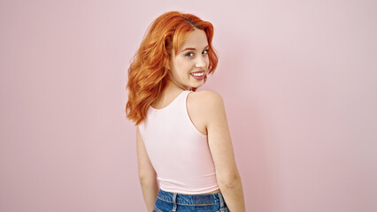 Young redhead woman smiling confident standing over isolated pink background