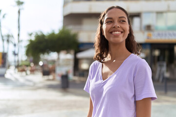 Young african american woman smiling confident looking to the side at street