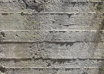 Reinforced concrete surface under oblique light. Clear imprints of the formwork