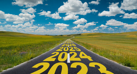 The word 2024 to 2029 written on road in the middle of empty countryside asphalt road at golden...