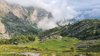 Mountain Landscape with a single farm house with dramatic clouds