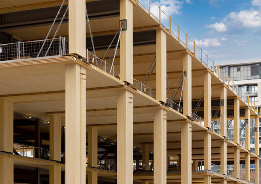 Laminated wood floors and supports of a mass timber multi story green, sustainable, residential high rise apartment or office building construction project