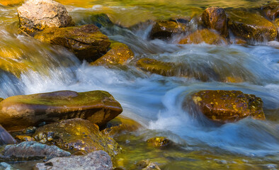 Fototapeta na wymiar closeup small waterfall on the mountain river