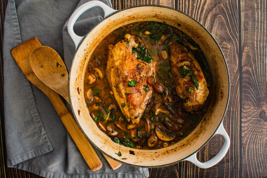 Chicken Pinot Noir with Wild Mushrooms and Fresh Basil: Chicken breasts in a cast-iron Dutch oven with a hearty tomato and mushroom sauce