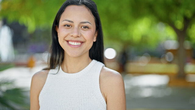 Young beautiful hispanic woman smiling confident standing at park