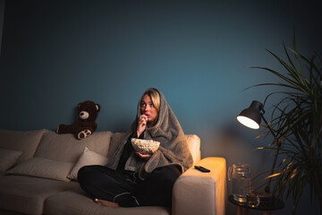 A girl home alone, spellbound by a horror film. Wide-eyed, she leans in, captivated by the...