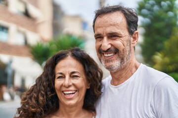 Fototapeta premium Man and woman couple smiling confident standing together at street