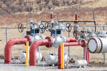 Typical high pressure oilfield gas pipeline valves and gauges equipment in a dry field